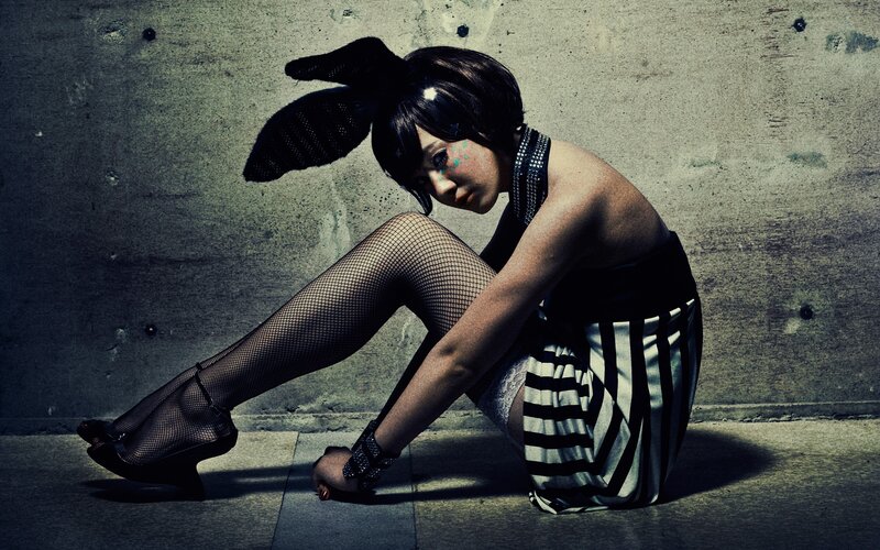 woman in striped dress sitting on floor