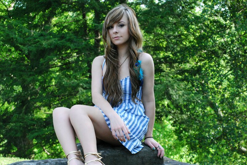 woman in striped dress sitting outdoors