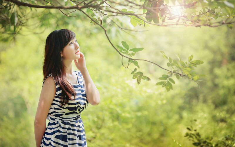 woman in striped dress under trees