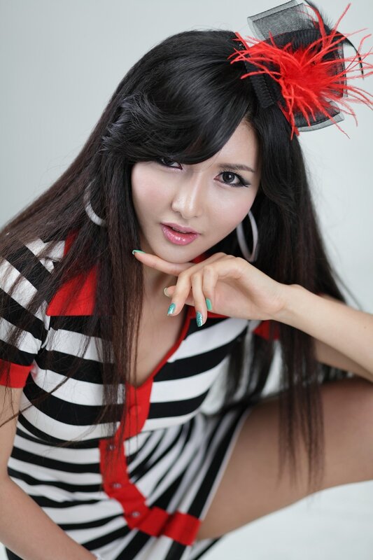 woman in striped dress with feather hair accessory