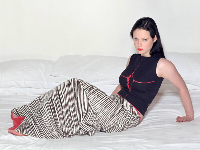 woman in striped pants on bed