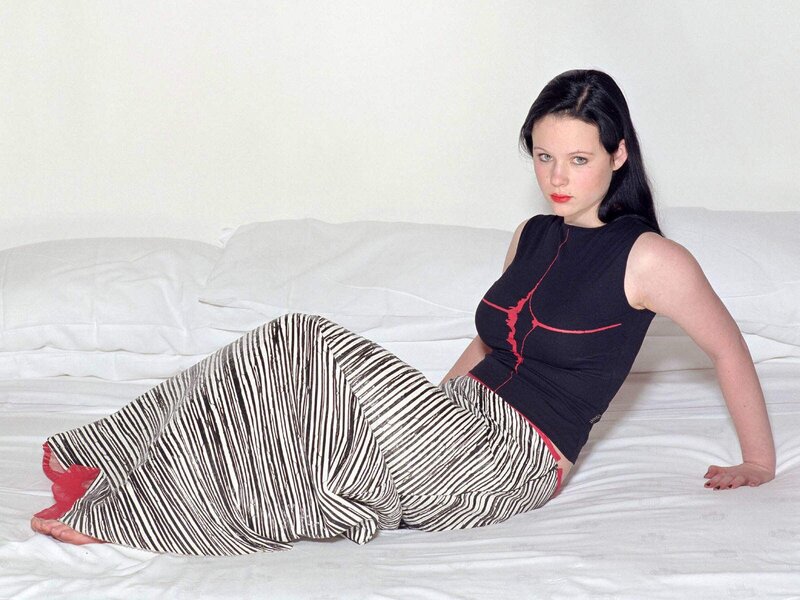 woman in striped pants on bed