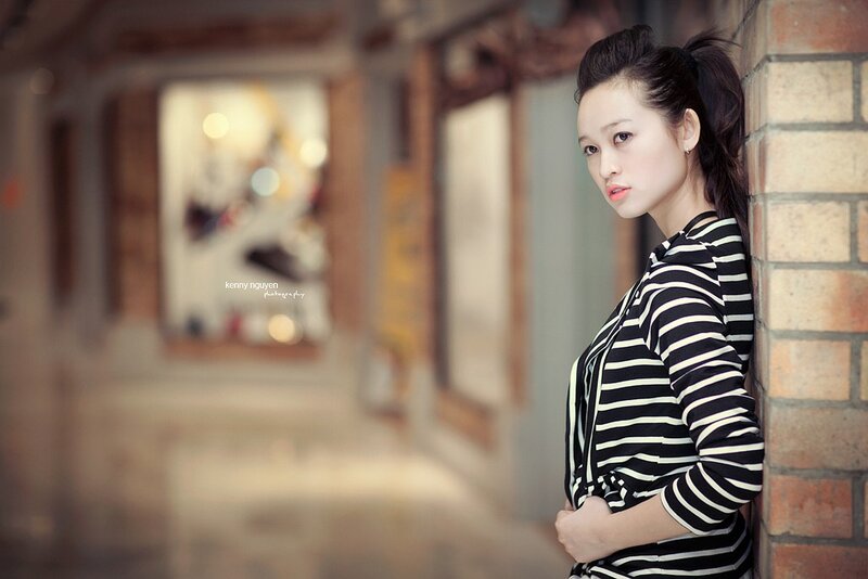 Woman in Striped Shirt — Black, Contemplative, Photograph, Brick Wall