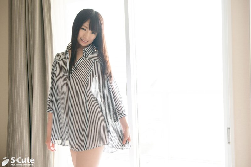 Woman in striped shirt by window