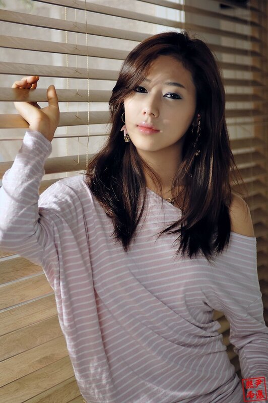 woman in striped shirt by window