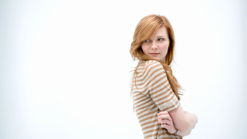 woman in striped shirt looking back
