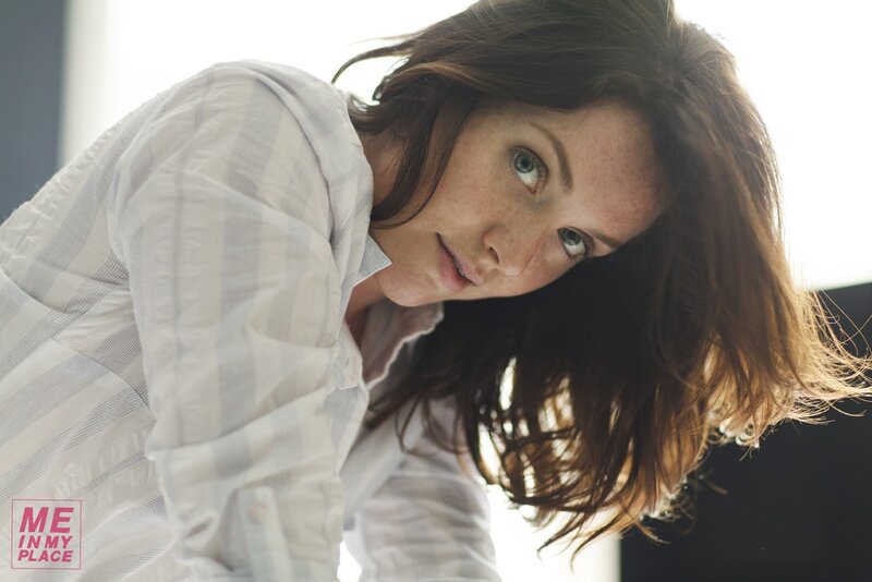woman in striped shirt looking down