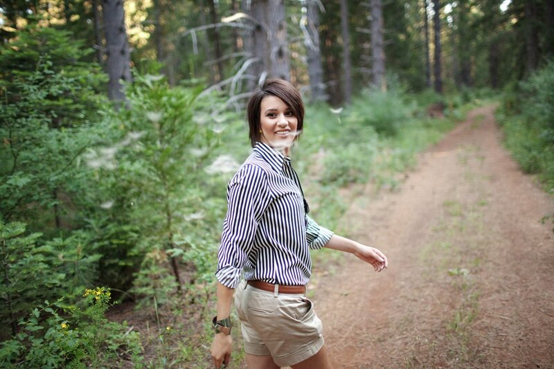 woman in striped shirt on forest path