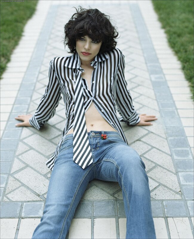 woman in striped shirt sitting on path