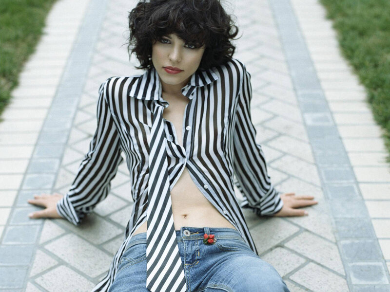 woman in striped shirt sitting on path