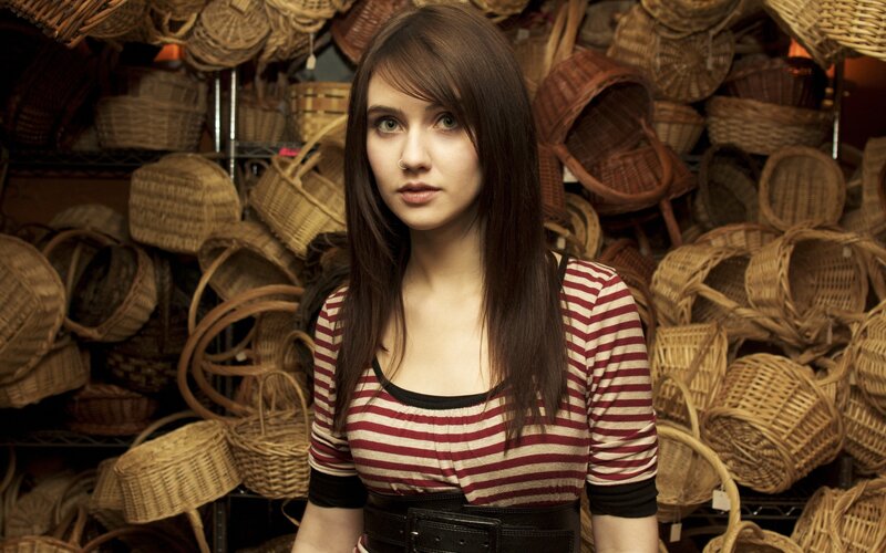 woman in striped shirt surrounded by baskets