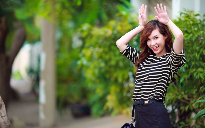 woman in striped shirt waving