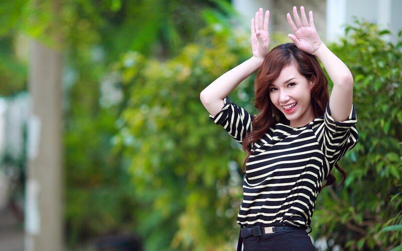 woman in striped shirt waving