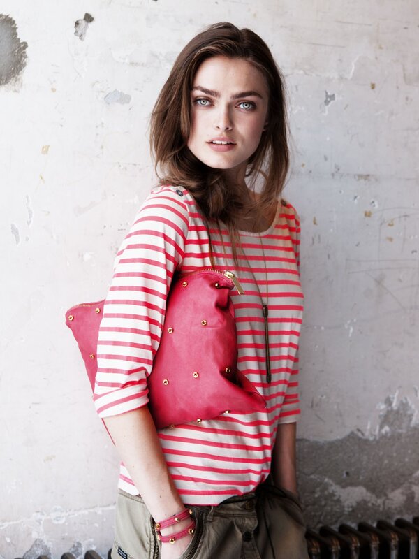 Woman in striped shirt with pink bag