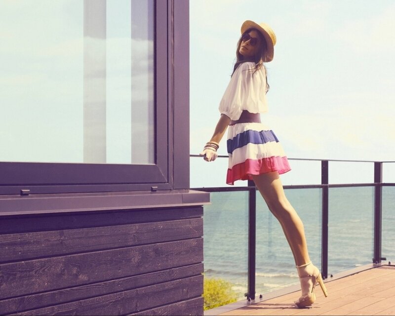 Woman in striped skirt on balcony