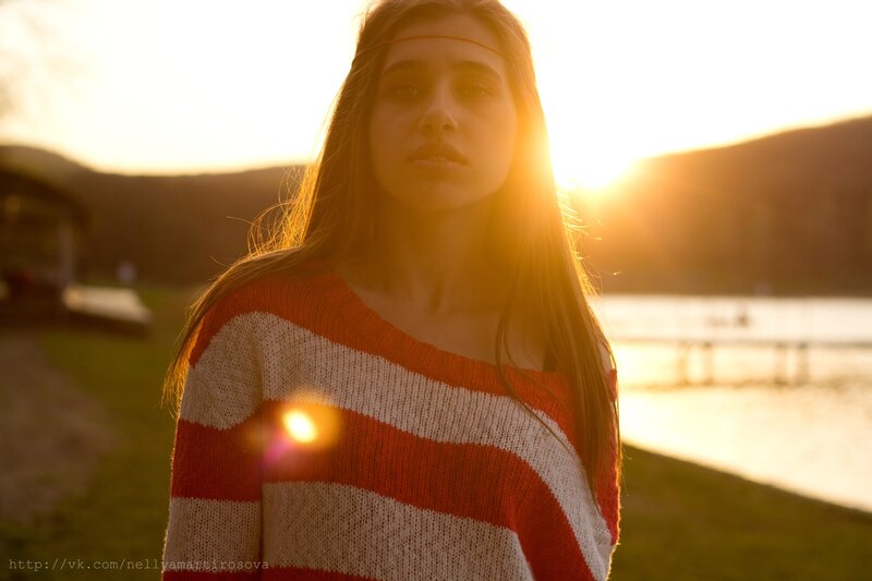 woman in striped sweater at sunset