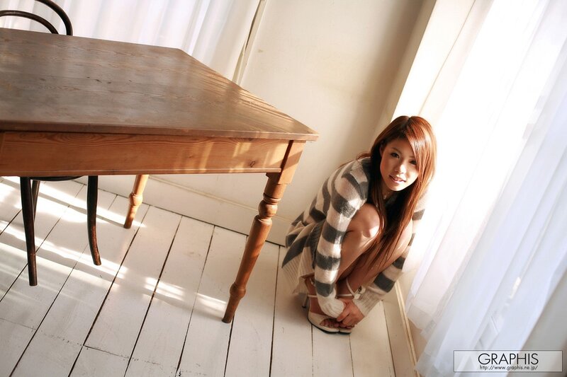 woman in striped sweater by window