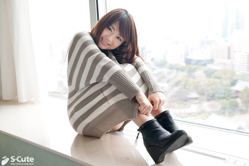 Woman in striped sweater by window