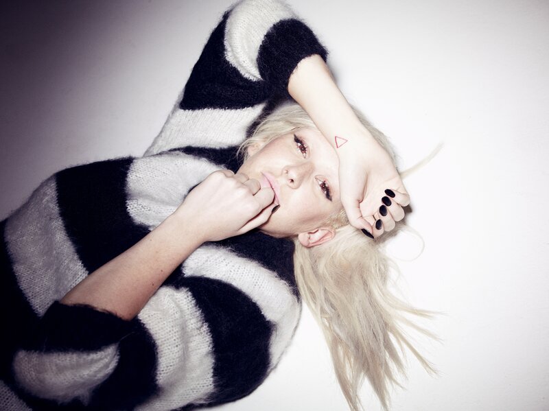 woman in striped sweater lying down