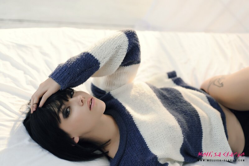 woman in striped sweater lying down