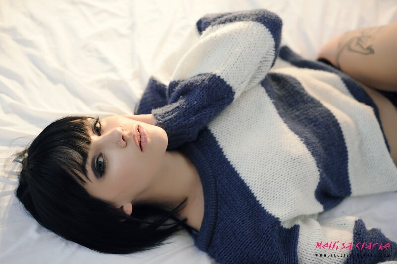 woman in striped sweater lying down