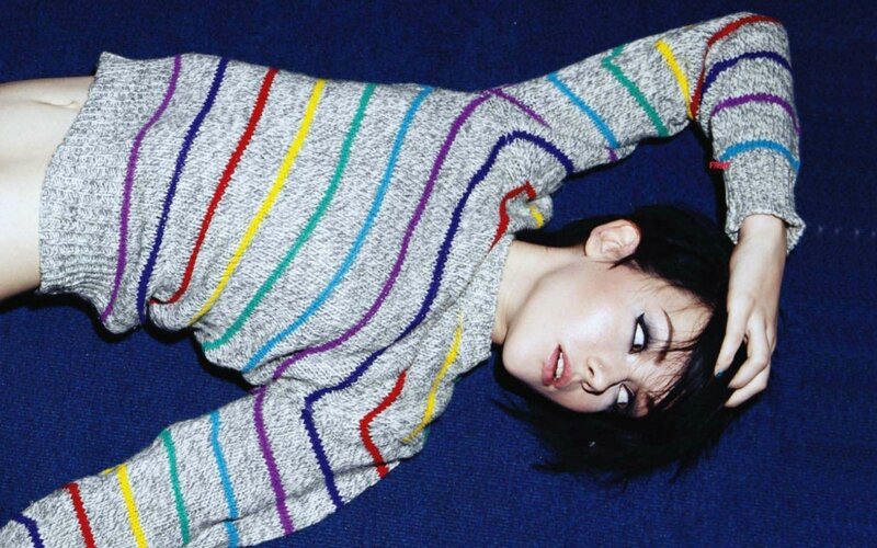 woman in striped sweater lying down