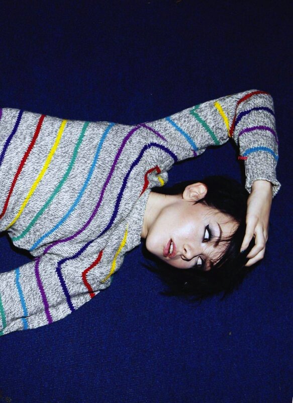 woman in striped sweater lying down