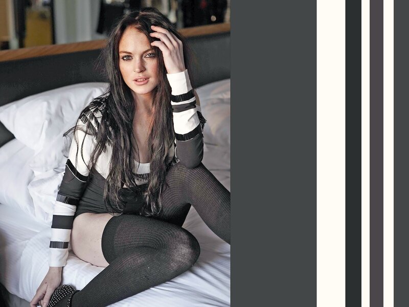 woman in striped sweater on bed