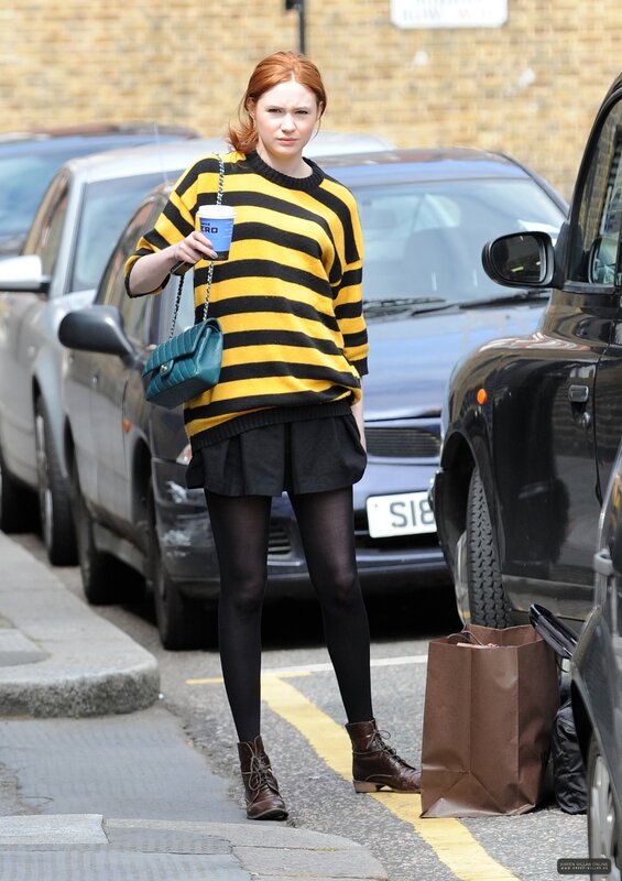 Woman in striped sweater on street