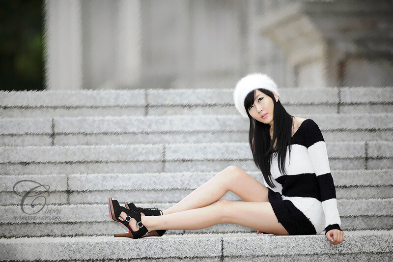 woman in striped sweater sitting on steps