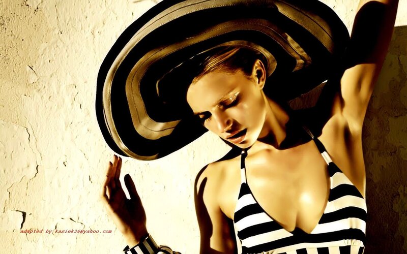 woman in striped swimsuit and hat
