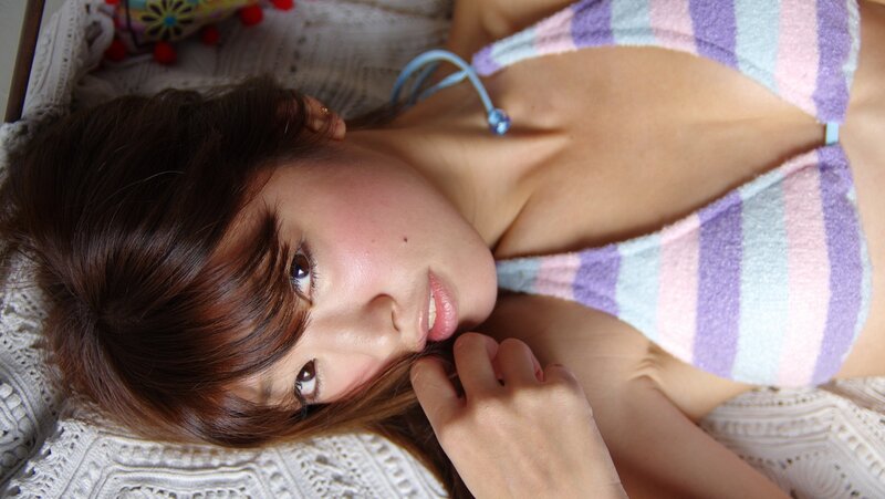 woman in striped swimsuit lying down