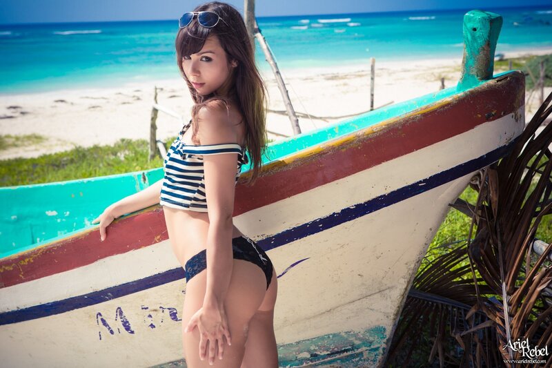 Woman in striped swimsuit on beach