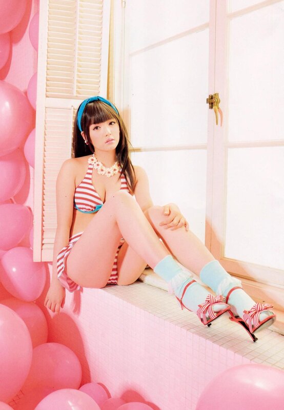 woman in striped swimsuit on pink set