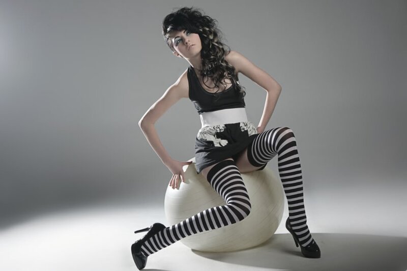 woman in striped tights on exercise ball