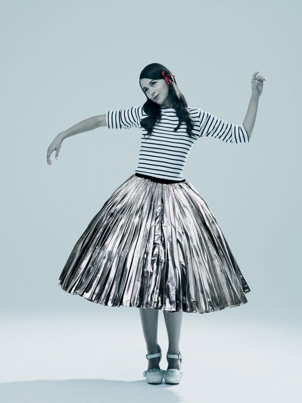 woman in striped top and pleated skirt