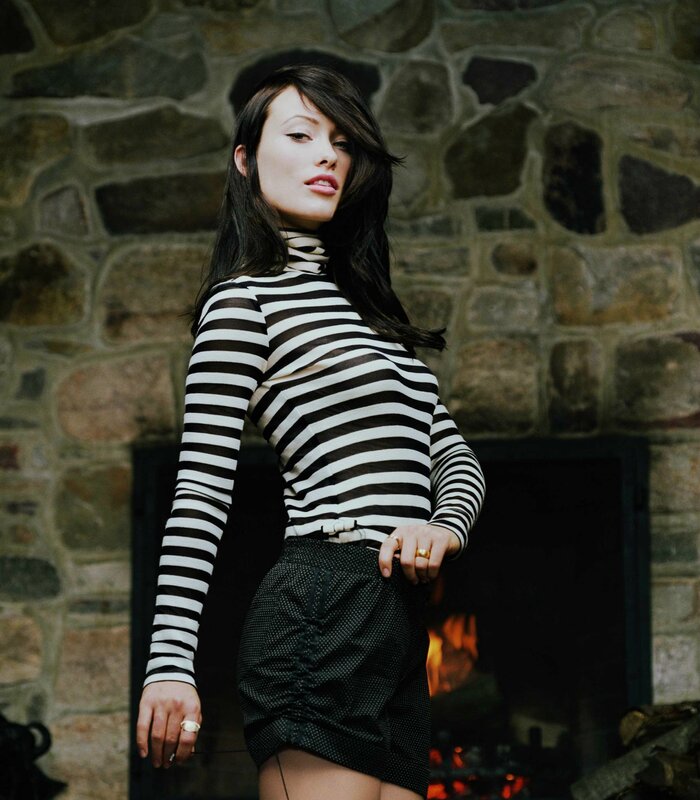 woman in striped top by fireplace