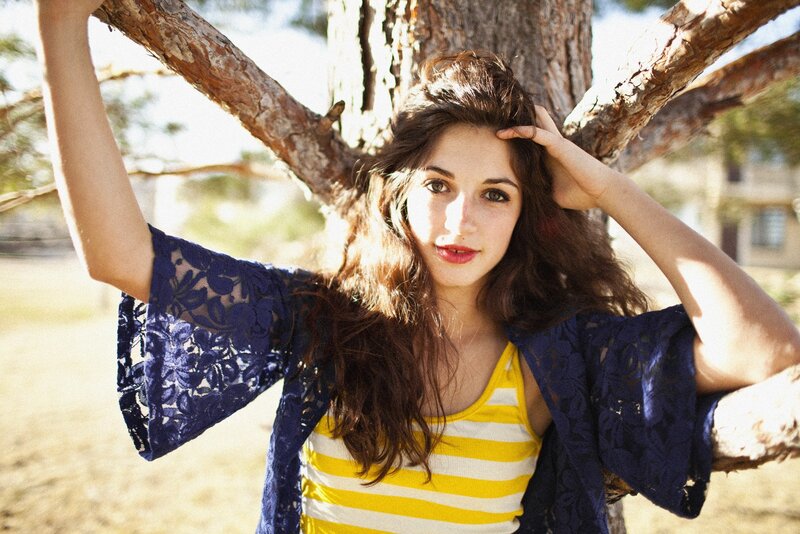 woman in striped top by tree