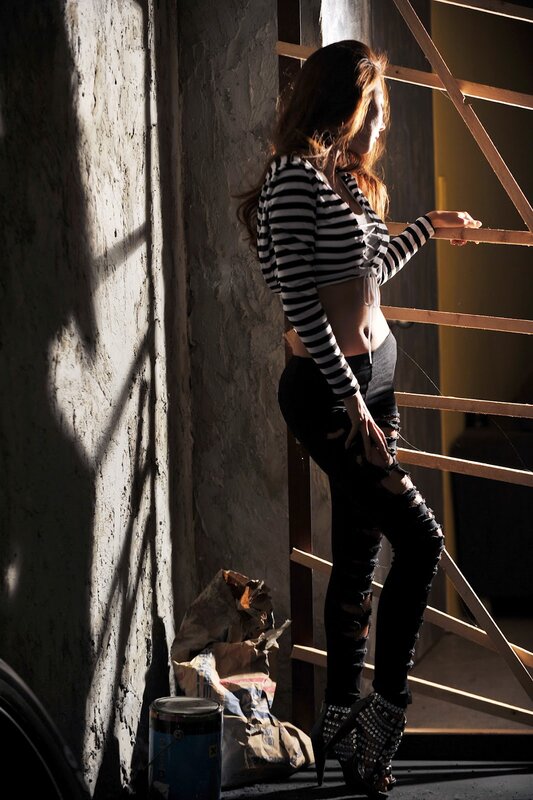 woman in striped top by window