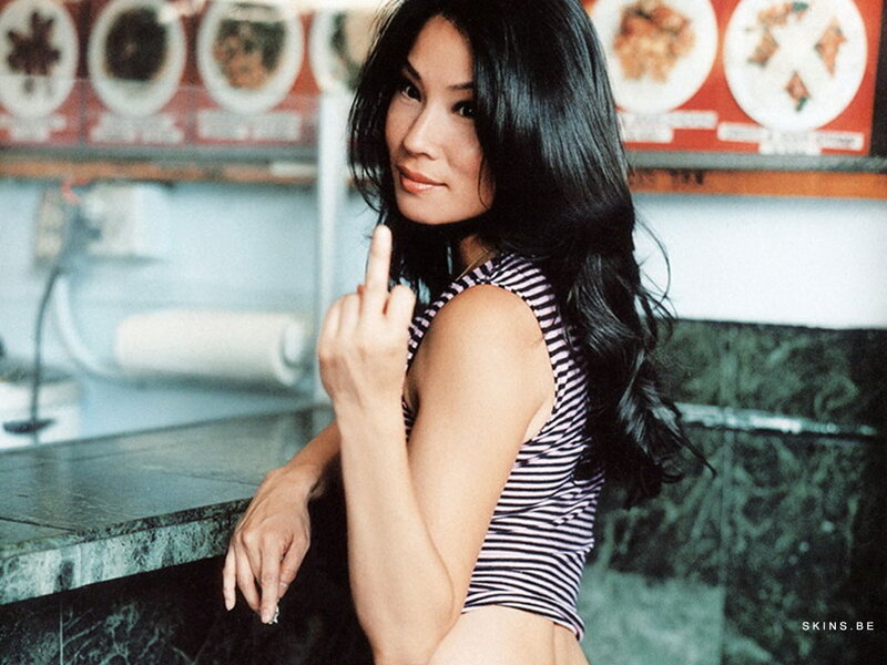 woman in striped top making hand gesture