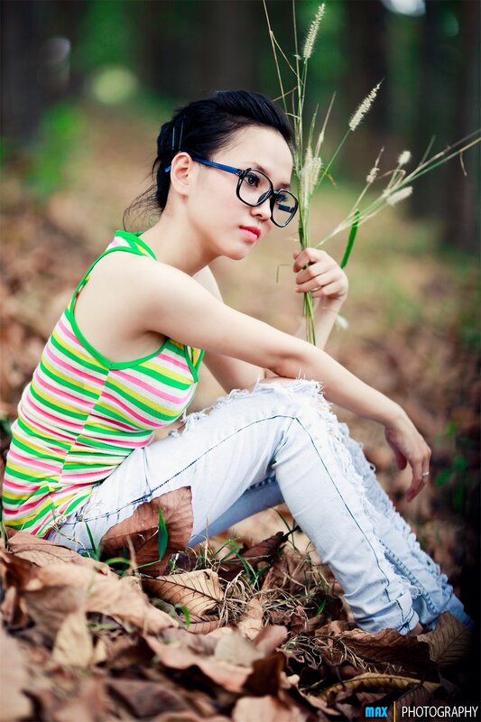 woman in striped top sitting outdoors