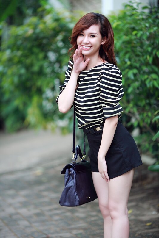 woman in striped top waving