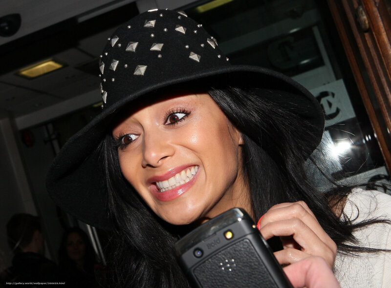 woman in studded hat smiling