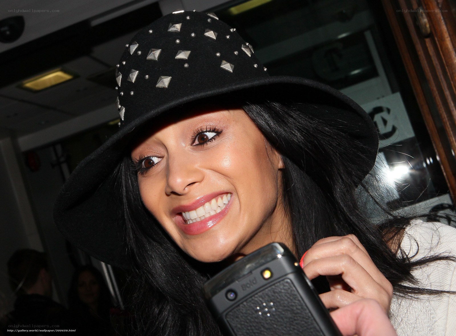 woman in studded hat smiling