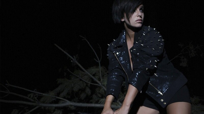 woman in studded jacket at night