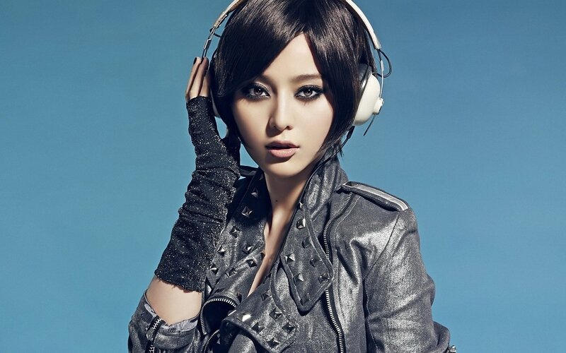 woman in studded jacket with headphones