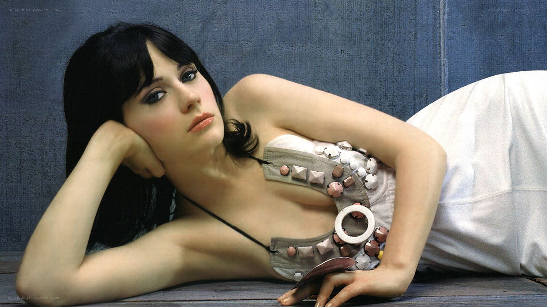 woman in studded top lying down