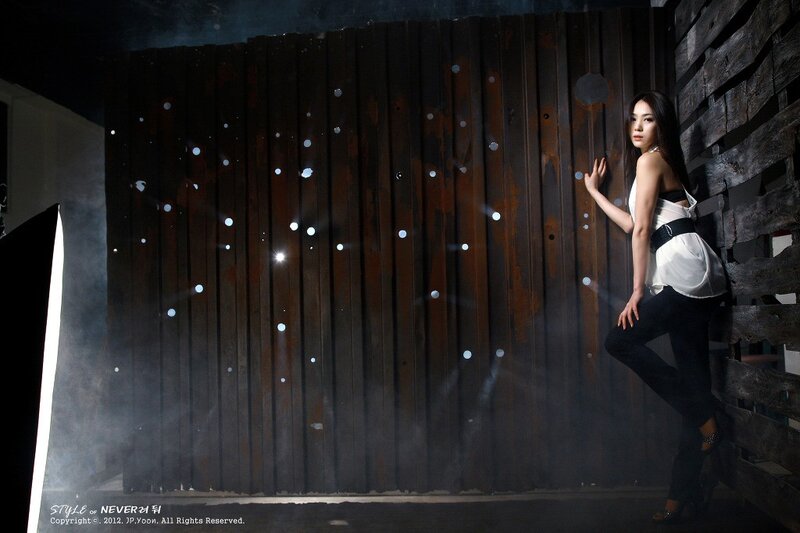 woman in studio with wooden backdrop
