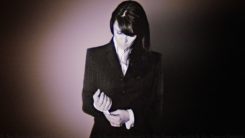 Woman in Suit Adjusting Cuff — Black