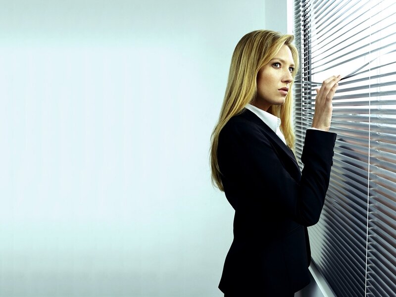 woman in suit at window